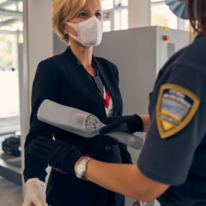 elegant-woman-medical-face-mask-passing-through-metal-detector-scanner-airport-terminal